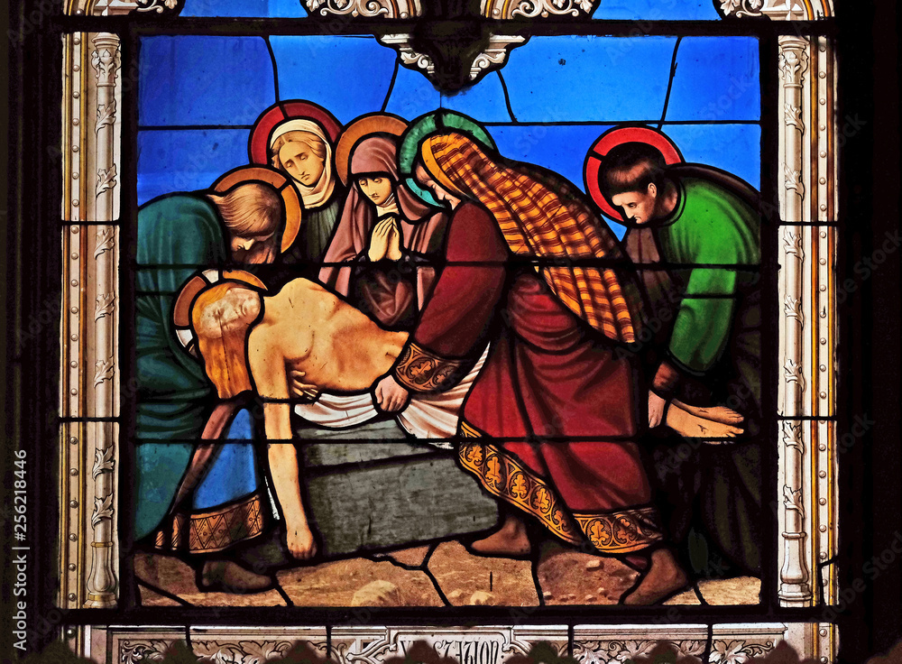 Fototapeta premium 14th Stations of the Cross, Jesus is laid in the tomb and covered in incense, stained glass windows in the Saint Eugene - Saint Cecilia Church, Paris, France 