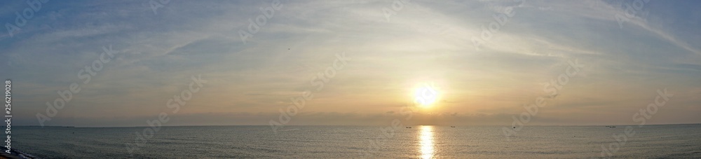 Panorama view of ocean sunrise, sea sunset,  Sun in the clouds horizon over the water.
