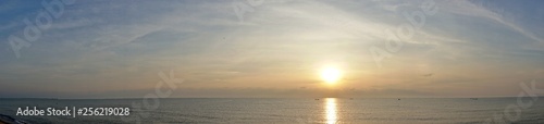 Panorama view of ocean sunrise, sea sunset, Sun in the clouds horizon over the water.