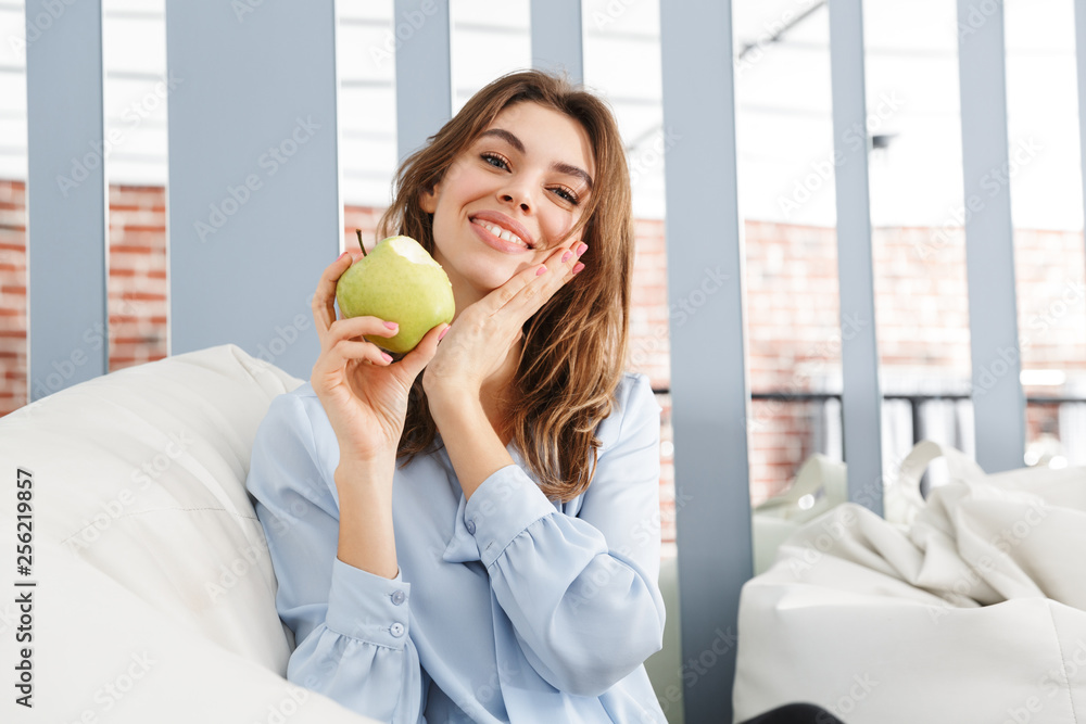 Beautiful young business woman sitting on a couch Beautiful young business woman sitting on a couch