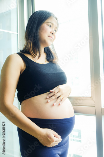 Young beautiful pregnant women standing in cozy room Free Download Young beautiful pregnant women standing in cozy room - GFXLoad