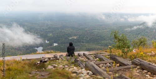 Obraz na plátně a woman looks over a foggy drizzly landscape in the Adirondacks