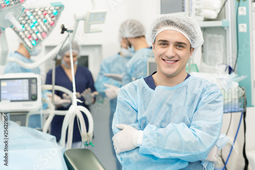 Cheerful professional surgeon posing confidently in an operating theatre