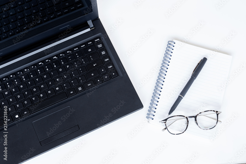 Open laptop with notebook and pen and eyeglasses on white background. Open laptop with notebook and pen and eyeglasses on white background.