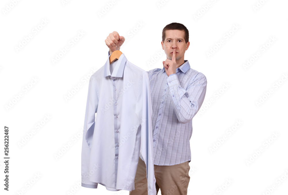 the man holds a coat hanger with a shirt on a white background the man holds a coat hanger with a shirt on a white background