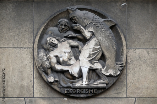 Exorcism. Stone relief at the building of the Faculte de Medicine Paris, France 
