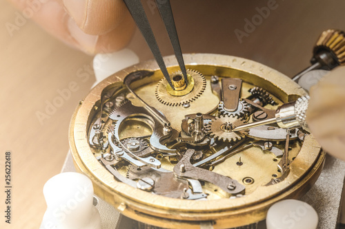 Professional watchmaker repairing watch photo