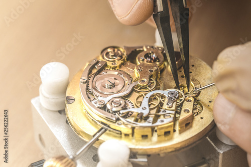 Professional watchmaker repairing watch photo