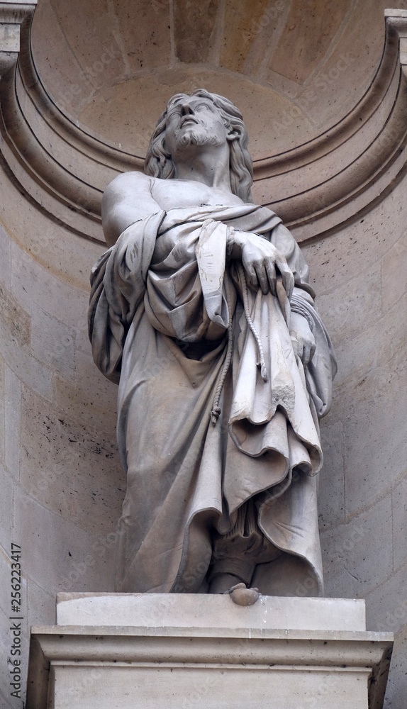 Obraz premium Saint Protais statue on the facade of Saint Gervais and Saint Protais Church, Paris, France