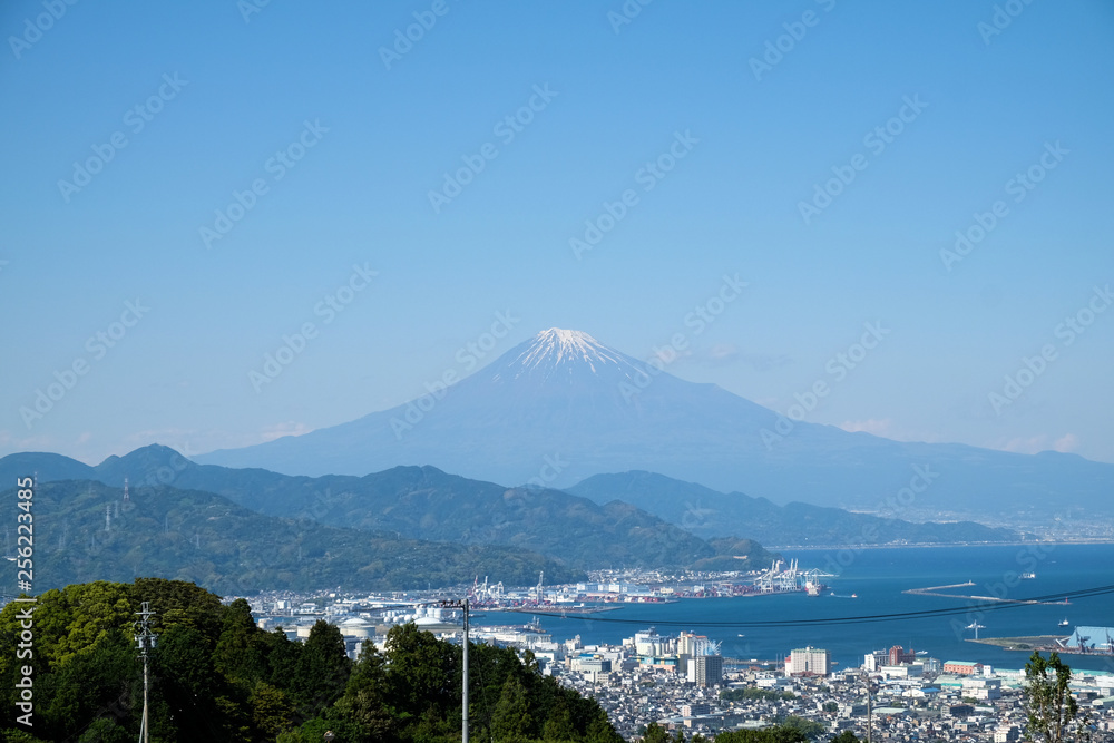 Japan city view over looking Mt. Fuji and the sea.