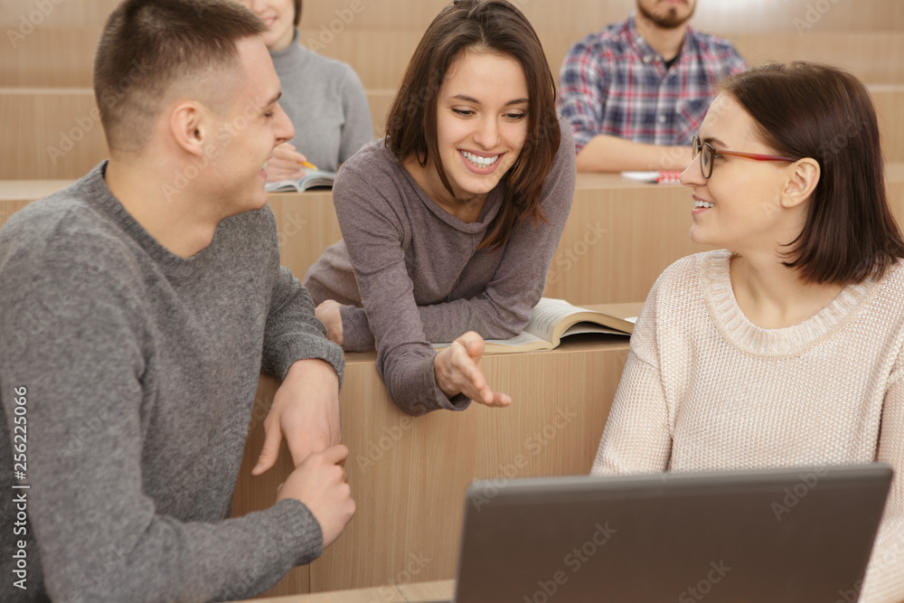 Students using laptop to complete an assignment Students using laptop to complete an assignment