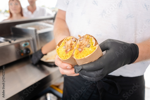 Chef in food truck showing a burrito