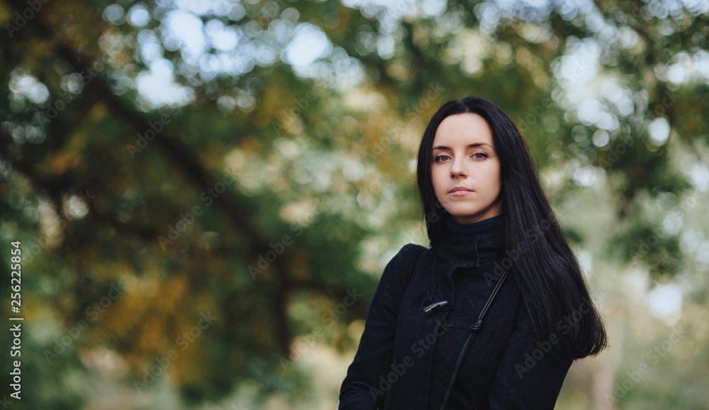Portrait of a beautiful brunette girl on nature. Cute woman in black clothes posing. Model and future bride. Portrait of a beautiful brunette girl on nature. Cute woman in black clothes posing. Model and future bride.