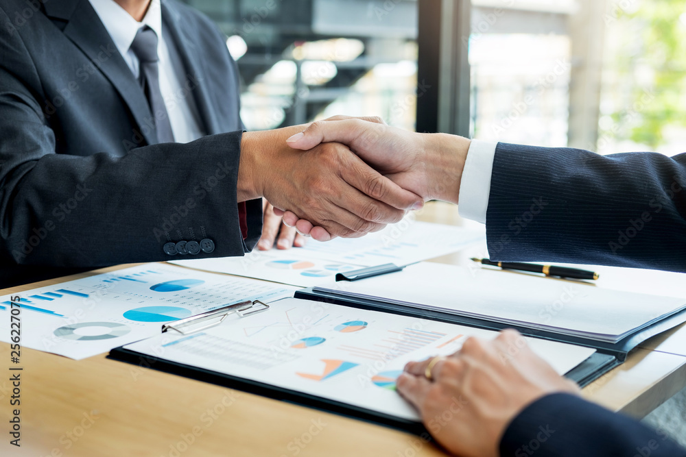 Negotiating business, Two confident business man shaking hands with partners together after finishing up a meeting succeeded Connection Deal Concept. Negotiating business, Two confident business man shaking hands with partners together after finishing up a meeting succeeded Connection Deal Concept.