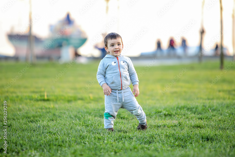 Baby's first steps.The first independent steps. Running toddler in the park. Baby's first steps.The first independent steps. Running toddler in the park.