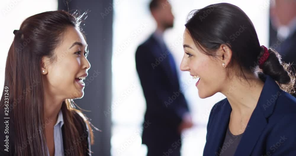 4K Beautiful business colleagues looking at digital tablet & having a friendly chat. Slow motion. 4K Beautiful business colleagues looking at digital tablet & having a friendly chat. Slow motion.