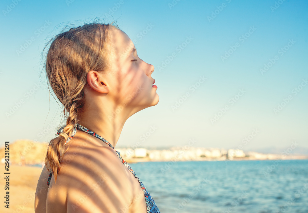 Cute girl on tropical beach. Young girl relaxing Cute girl on tropical beach. Young girl relaxing
