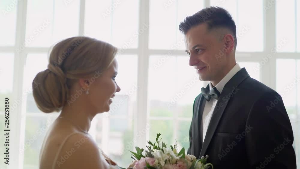 A bride and groom see each other for the first time on their wedding day and share a first look moment before the ceremony. The groom sees the bride for the first time on the wedding day A bride and groom see each other for the first time on their wedding day and share a first look moment before the ceremony. The groom sees the bride for the first time on the wedding day