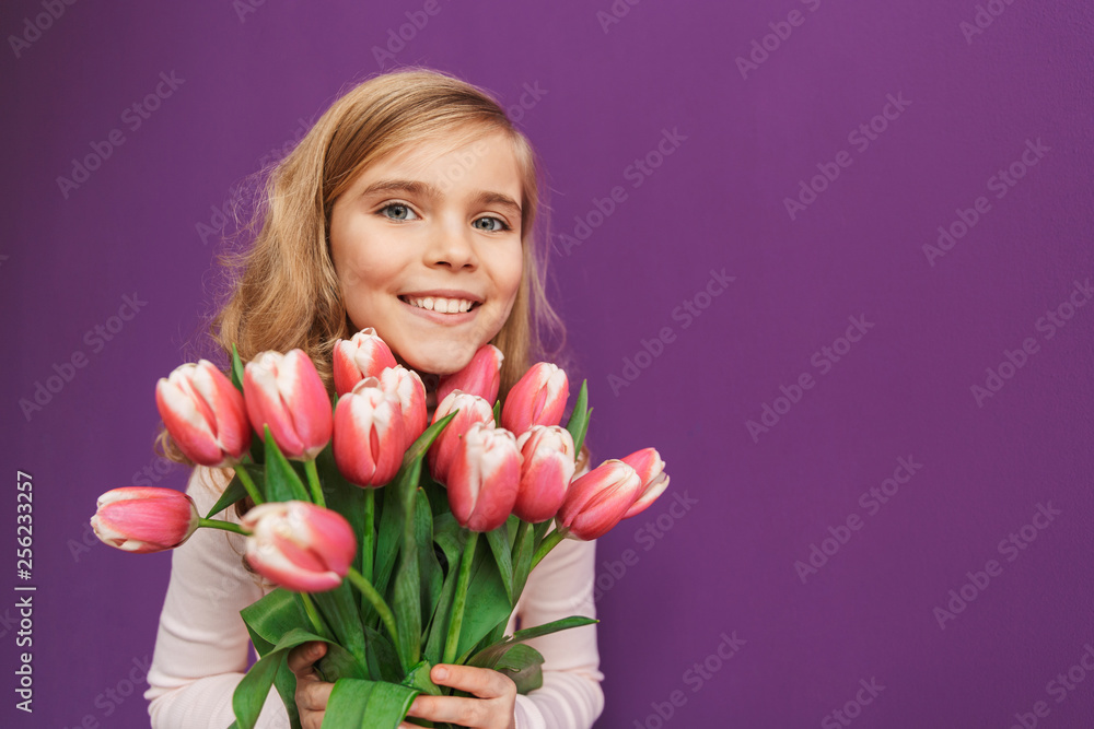 Portrait of a smiling little girl holding bouquet of tulips Portrait of a smiling little girl holding bouquet of tulips