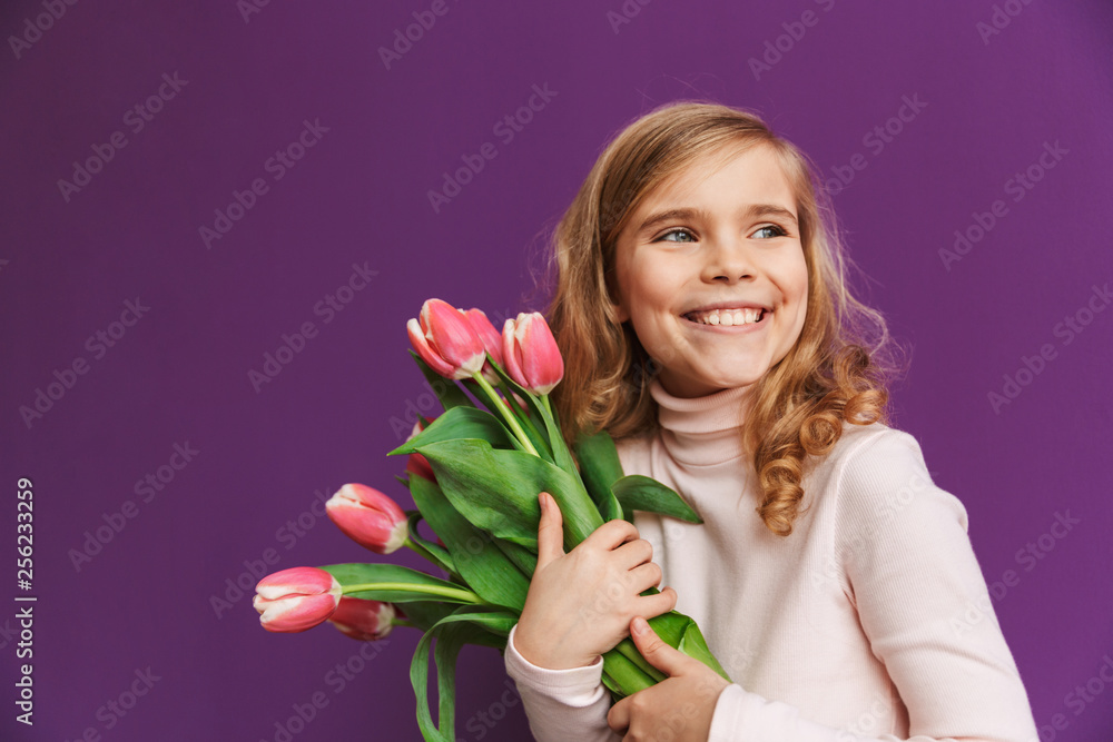 Portrait of a smiling little girl holding bouquet of tulips Portrait of a smiling little girl holding bouquet of tulips