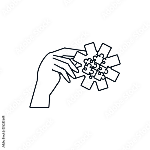 hand with puzzle pieces in shape pinion