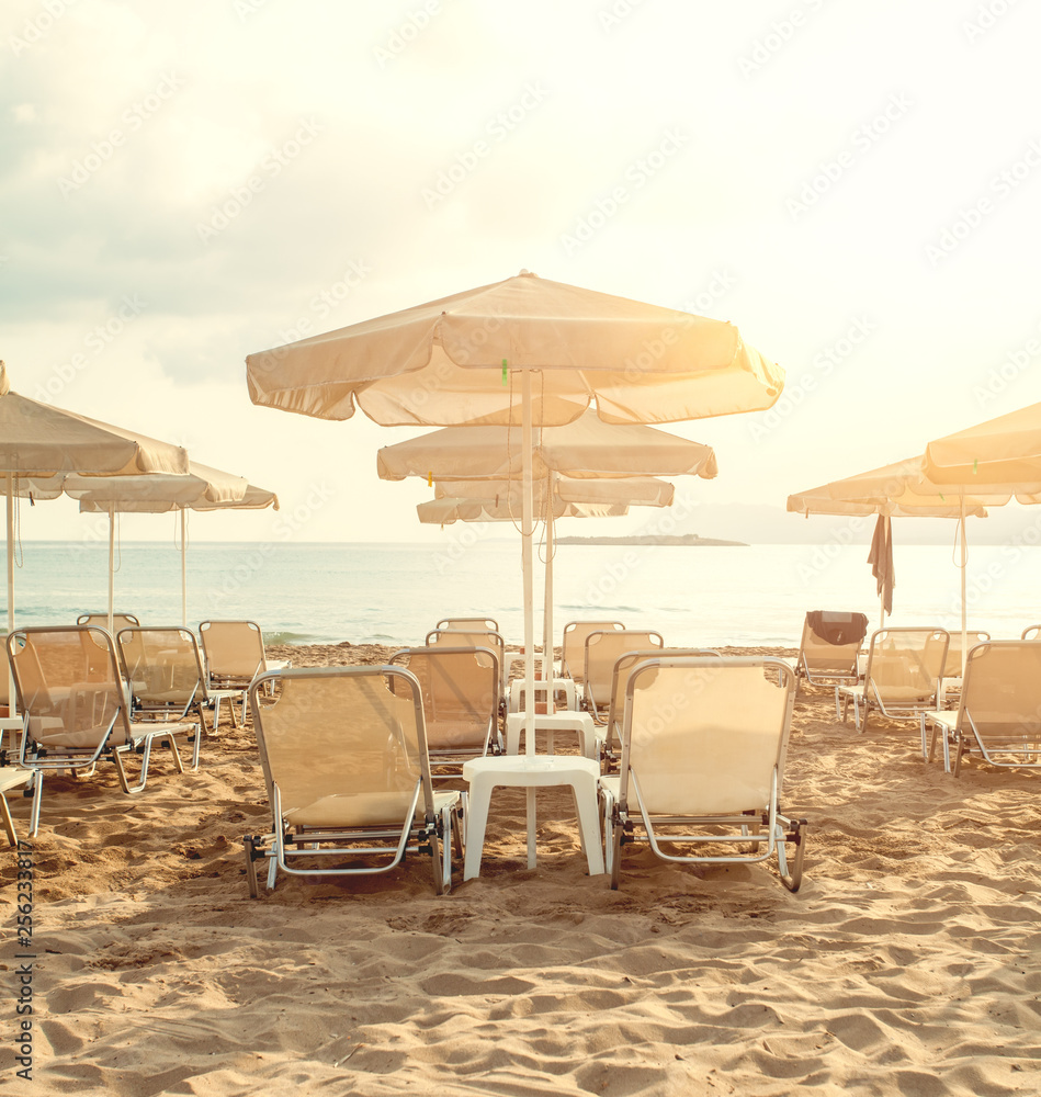 Sea beach with umbrellas and sunbeds. Summer holiday and relaxation concept