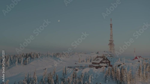 Wallpaper Mural Aerial drone view of shelter and transmitter tower at sunrise in winter in mountains with full moon in background  Torontodigital.ca