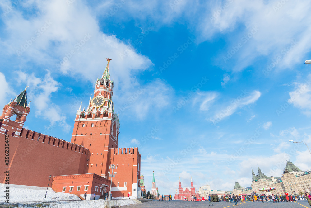 MOSCOW, RUSSIA - Febuary 17, 2019: Spasskaya Tower of Moscow Kremlin and Cathedral of Vasily the Blessed (Saint Basil's Cathedral) on Red Square