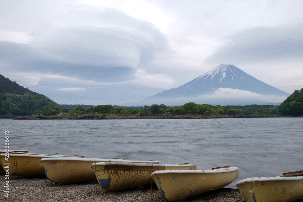 Beautiful view of Lake Saiko in Japan with the rowboat parked on the waterfront and Mountain Fuji background