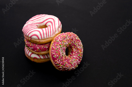 Picture of donuts frosted, pink glazed and sprinkles donuts isolated on white background