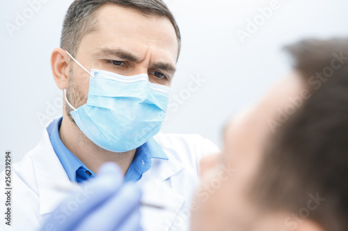 Professional dentist working with his patient