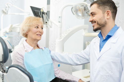 Professional dentist and his senior patient