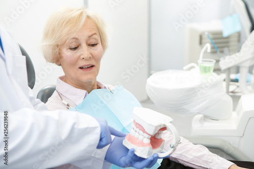 Professional dentist and his senior patient
