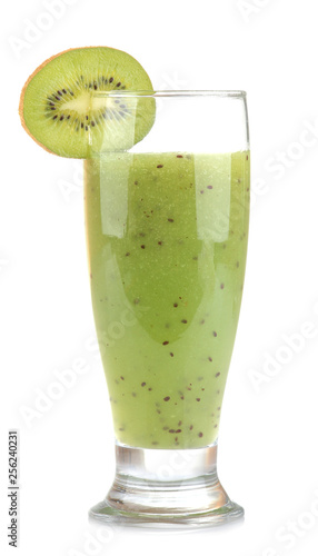 Kiwi smoothies in a glass next to fresh kiwi slices on a white isolated background. fruit drink.