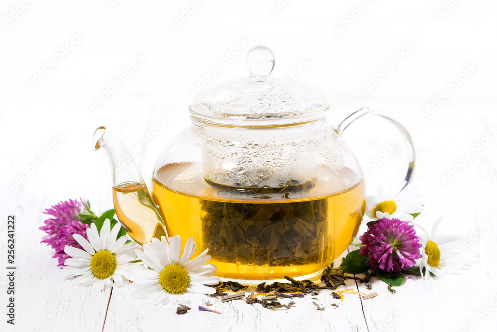 fragrant herbal tea in a glass teapot on white background fragrant herbal tea in a glass teapot on white background