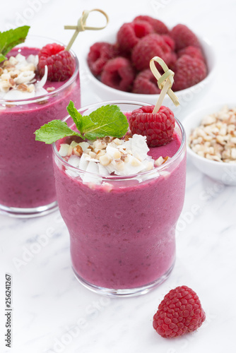 fresh berry smoothies with nuts, closeup vertical