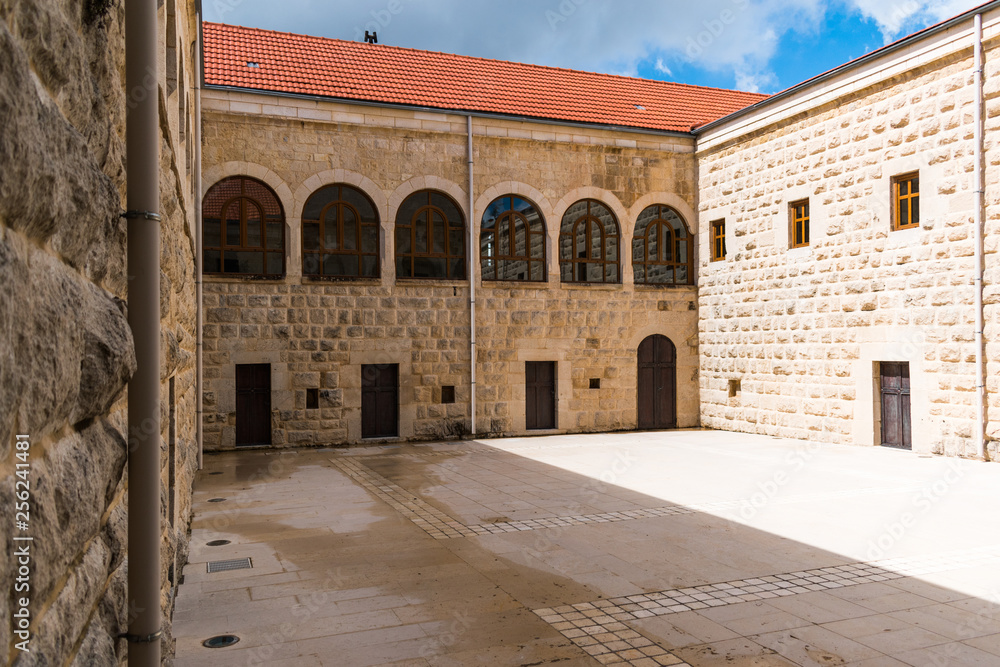 this is a capture of an old Monastery renovated in north Lebanon and it is dated to 1600 and you can see the white stone architecture with some arc windows  