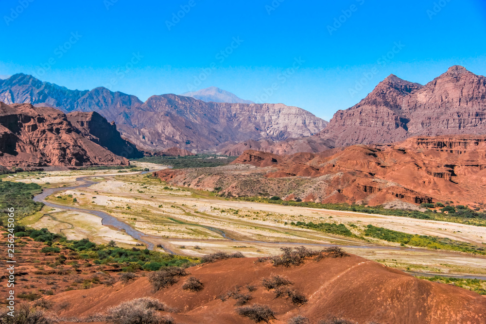 Red mountains landscape with a dry river down the valley Red mountains landscape with a dry river down the valley