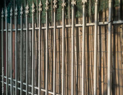 Old metal fence detail close up with wood texture