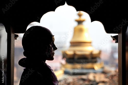 Silhouette of a young woman on the background of the pagoda. Nepal