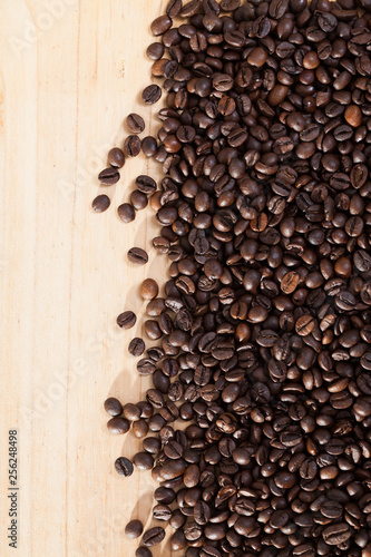 Image of   fresh coffee beans on natural wooden background