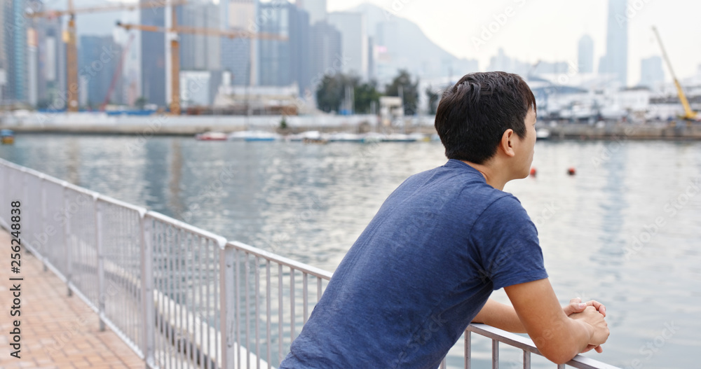 Man look at the sea and think of something in Hong Kong Man look at the sea and think of something in Hong Kong
