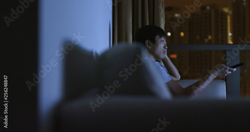 Asian man watch tv at night
