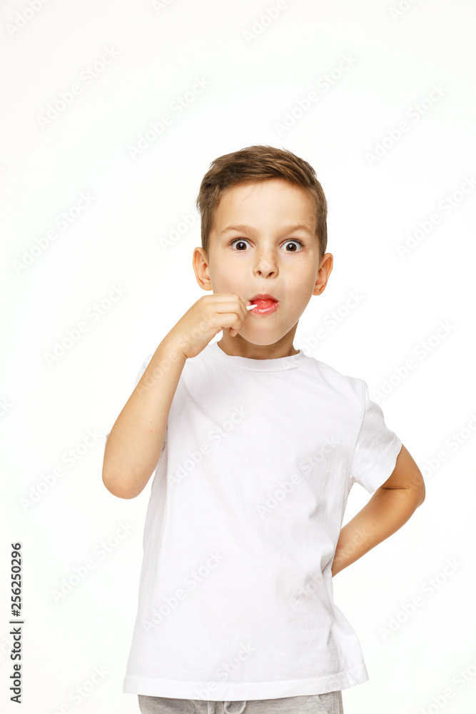 little boy with a lollipop on a white background little boy with a lollipop on a white background