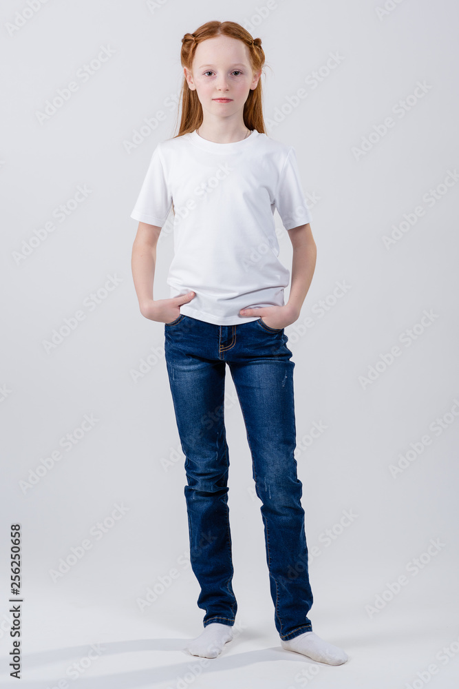 Fototapeta premium Young caucasian, european woman, girl in white t-shirt. Girl posing in a white T-shirt. Girl in white t-shirt. T-shirt with copy space.
