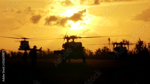 Soldiers and helicopters in the sunset 2 photo