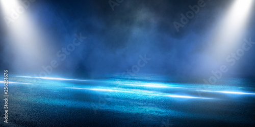 Background of the room with concrete pavement. Blue and pink neon light. Smoke, fog, wet asphalt with reflection of lights. Abstract light, searchlight rays. Night view of the street with lights, dark © MiaStendal