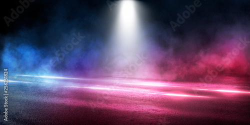 Background of the room with concrete pavement. Blue and pink neon light. Smoke  fog  wet asphalt with reflection of lights. Abstract light  searchlight rays. Night view of the street with lights  dark