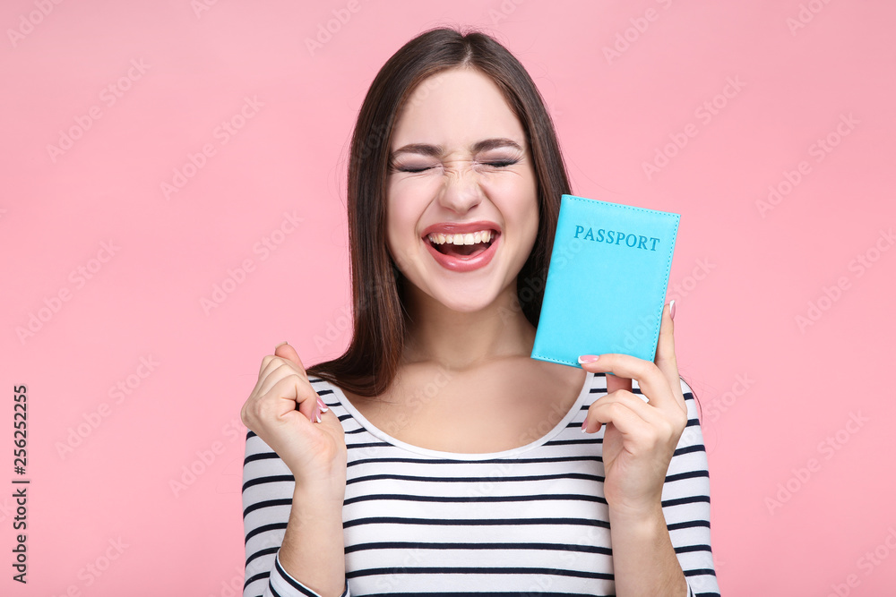 Beautiful young woman with passport on pink background Beautiful young woman with passport on pink background