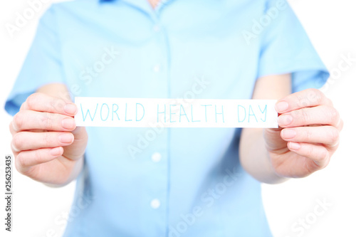 Paper with text World Health Day in female hands